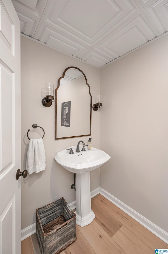 bathroom with hardwood / wood-style floors and sink