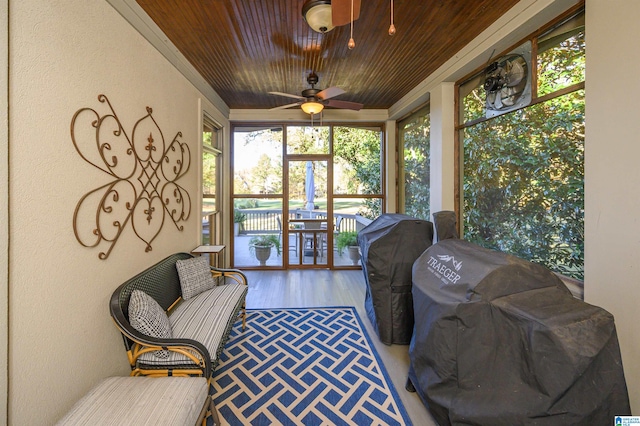 sunroom / solarium featuring ceiling fan and wood ceiling