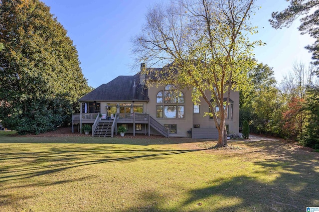 back of house featuring a yard and a wooden deck