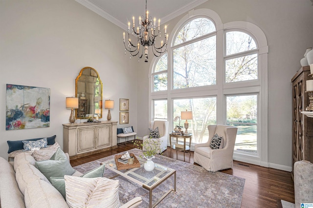 living room featuring plenty of natural light, dark hardwood / wood-style flooring, a towering ceiling, and ornamental molding