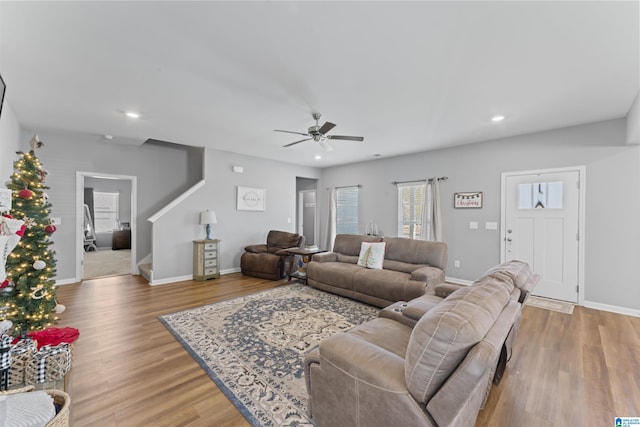 living room with hardwood / wood-style flooring and ceiling fan