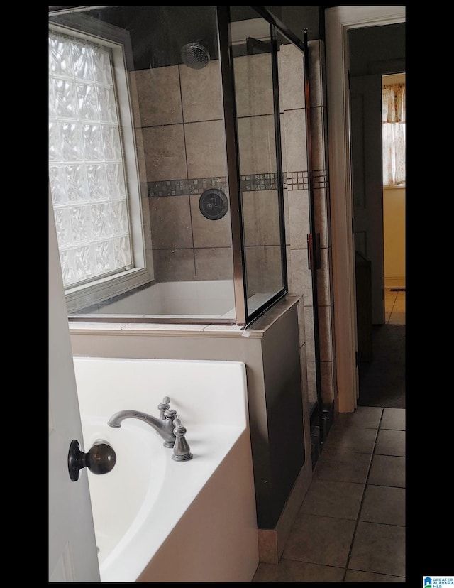 bathroom featuring tile patterned flooring and independent shower and bath