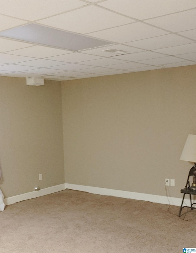 interior space featuring carpet floors and a paneled ceiling