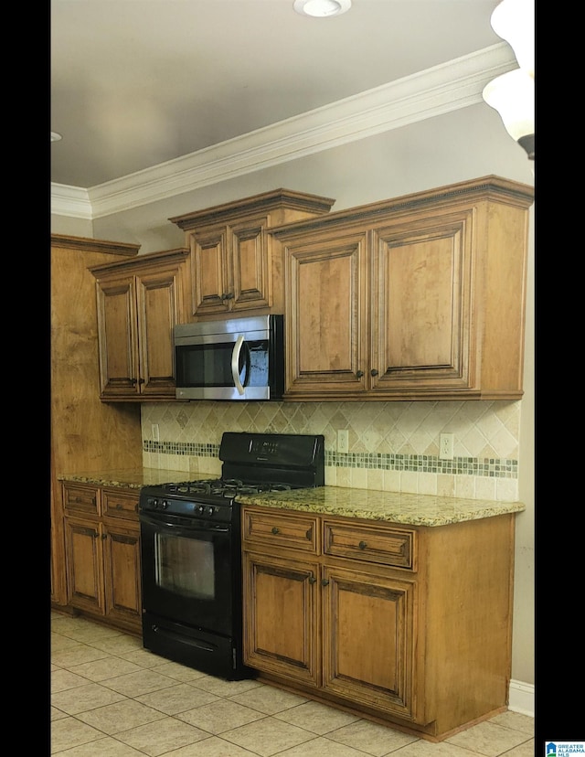 kitchen with crown molding, decorative backsplash, light stone countertops, light tile patterned floors, and black gas range oven