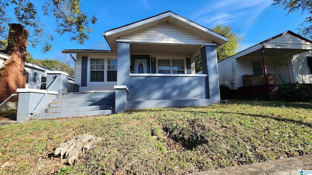 bungalow-style house with a front lawn