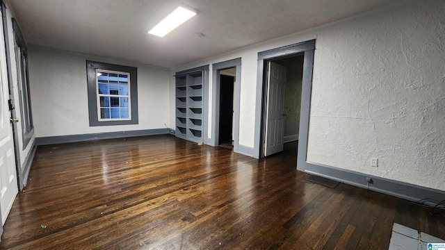 empty room featuring dark hardwood / wood-style flooring