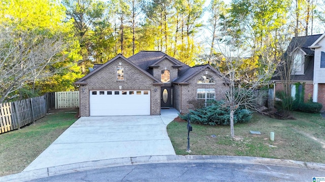 view of front of property with a front yard and a garage