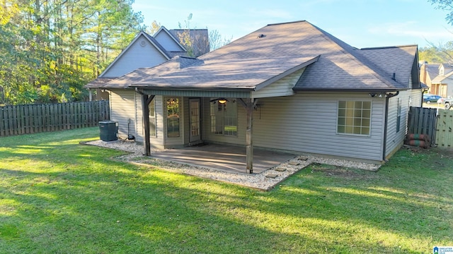 back of house featuring a lawn, a patio, and central AC