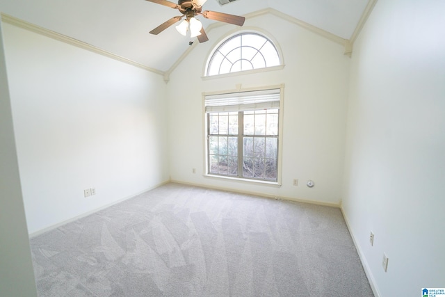 spare room featuring ceiling fan, light colored carpet, crown molding, and high vaulted ceiling