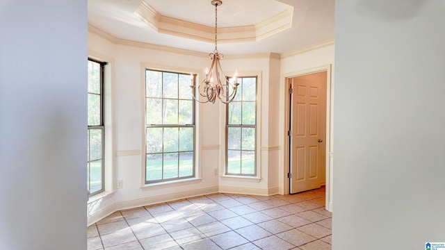 unfurnished dining area with a raised ceiling, crown molding, and a healthy amount of sunlight