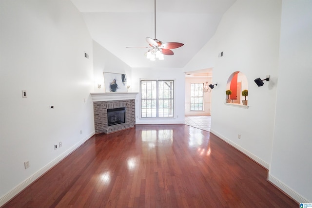 unfurnished living room with ceiling fan, a fireplace, high vaulted ceiling, and dark hardwood / wood-style floors