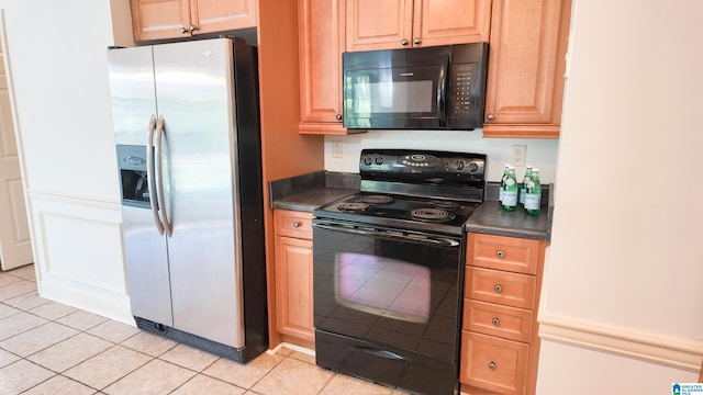 kitchen with light tile patterned flooring and black appliances