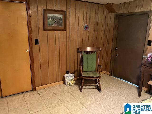 sitting room featuring wood walls