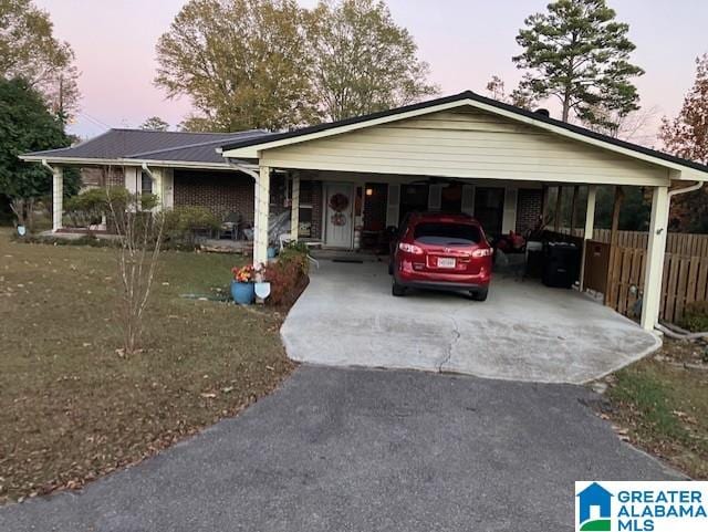 single story home with a yard and a carport