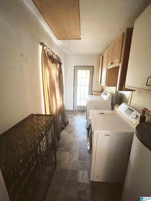 laundry area with washer and clothes dryer and cabinets