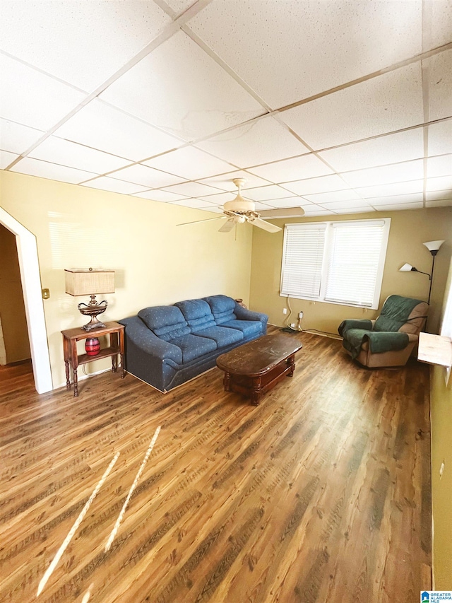 living room featuring a paneled ceiling and hardwood / wood-style flooring