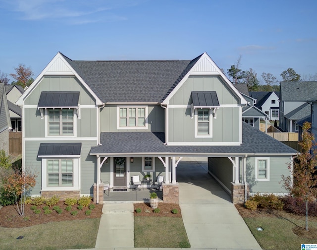 view of front facade with covered porch and a carport