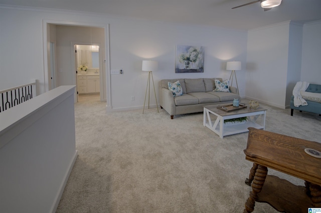 living room featuring ceiling fan, light colored carpet, and ornamental molding