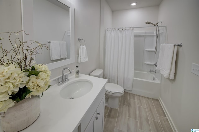 full bathroom with vanity, wood-type flooring, shower / tub combo, and toilet