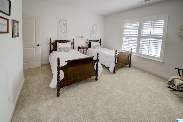 bedroom featuring light colored carpet