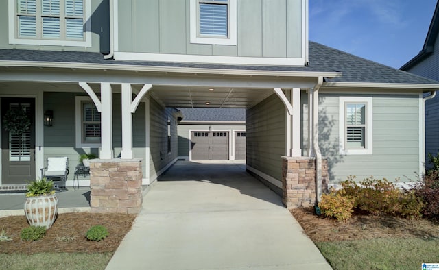 exterior space featuring a porch, a garage, a carport, and an outdoor structure