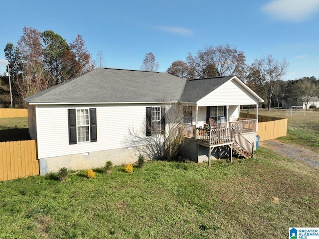 back of property featuring a lawn and a porch