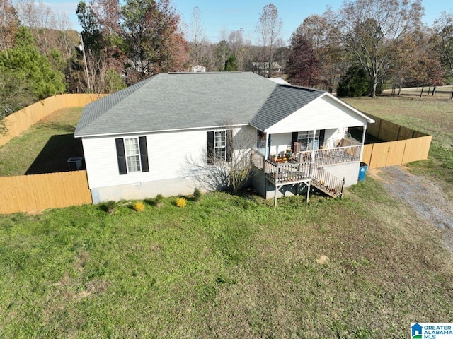 back of house featuring covered porch and a yard