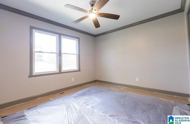 spare room featuring ceiling fan and ornamental molding