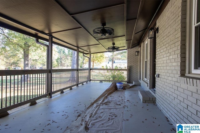 unfurnished sunroom featuring ceiling fan and plenty of natural light