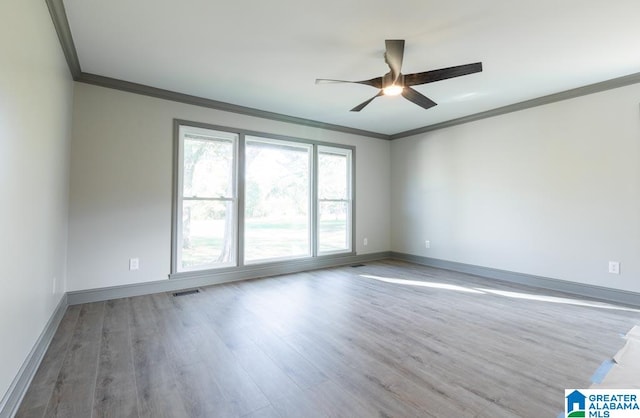 spare room with hardwood / wood-style floors, ceiling fan, and crown molding