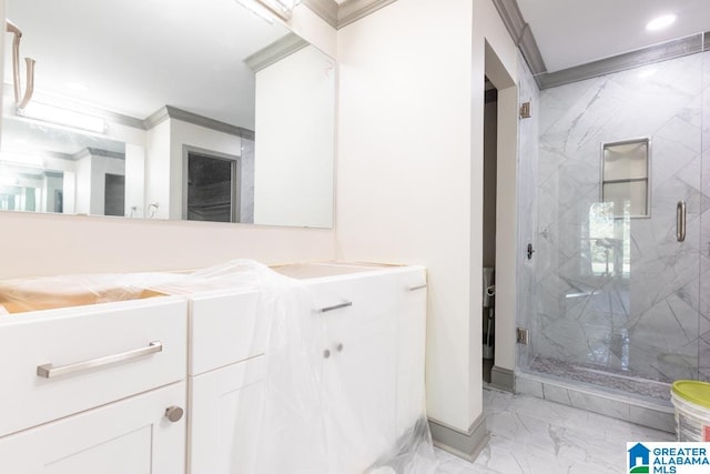 bathroom with vanity, an enclosed shower, and ornamental molding