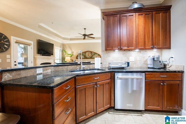 kitchen with dark stone countertops, dishwasher, ornamental molding, and sink