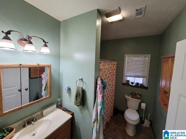 bathroom with a shower with curtain, tile patterned flooring, a textured ceiling, toilet, and vanity