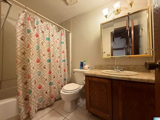 full bathroom featuring tile patterned flooring, a textured ceiling, toilet, vanity, and tile walls