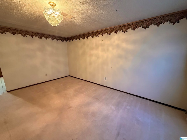 unfurnished room featuring carpet flooring and a textured ceiling