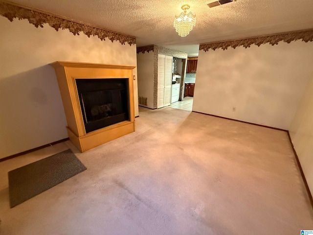 unfurnished living room featuring carpet flooring and a textured ceiling