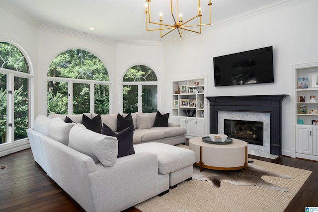 living room featuring dark hardwood / wood-style floors, ornamental molding, and a high end fireplace