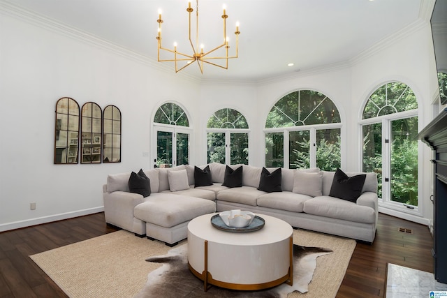 living room with a chandelier, dark hardwood / wood-style floors, and crown molding