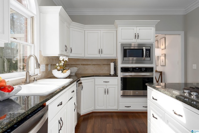 kitchen featuring a wealth of natural light, white cabinets, and stainless steel appliances