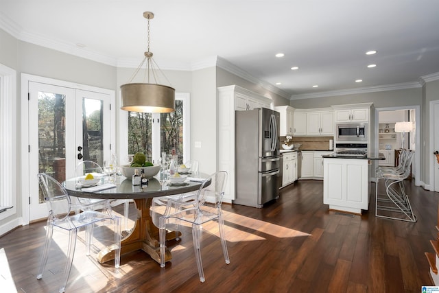 dining space with dark hardwood / wood-style flooring, french doors, and ornamental molding