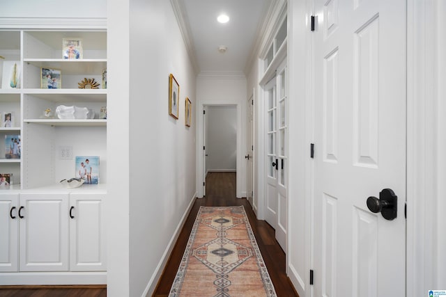 hall with dark wood-type flooring and ornamental molding