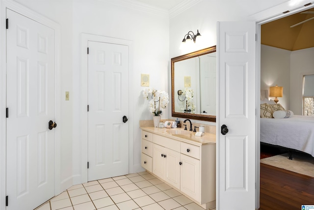 bathroom featuring hardwood / wood-style floors, vanity, and crown molding