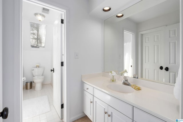 bathroom with tile patterned floors, vanity, and toilet