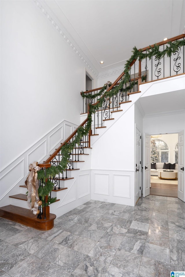 staircase featuring ornamental molding