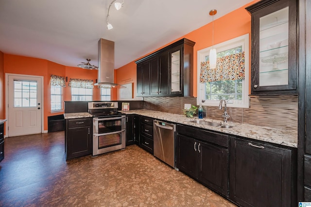 kitchen featuring sink, hanging light fixtures, stainless steel appliances, tasteful backsplash, and island range hood