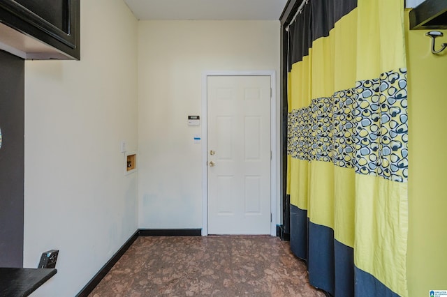 entryway with dark colored carpet