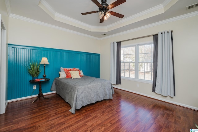 bedroom with dark hardwood / wood-style flooring, a raised ceiling, ceiling fan, and crown molding