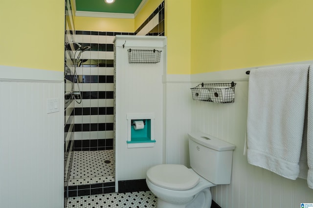 bathroom with tile patterned floors, toilet, and ornamental molding