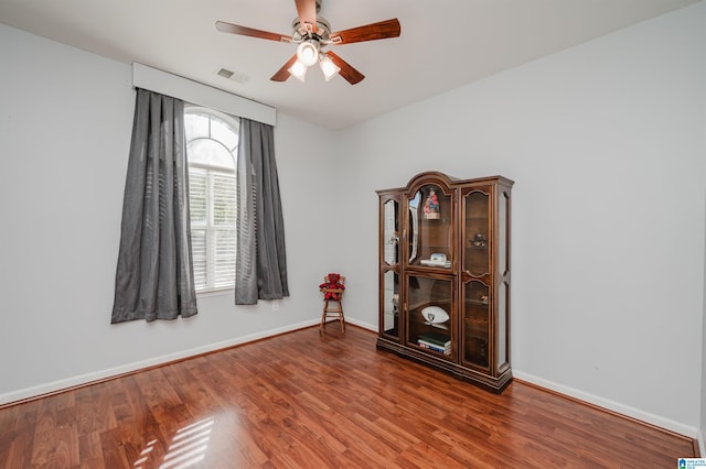 unfurnished room with ceiling fan and wood-type flooring