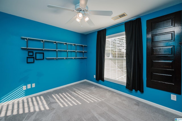 spare room with carpet floors and ceiling fan